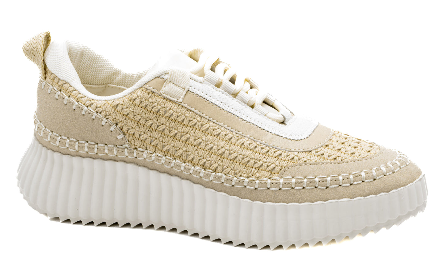 Beige woven sneakers with intricate crochet detailing, suede accents, and a chunky white ribbed sole.