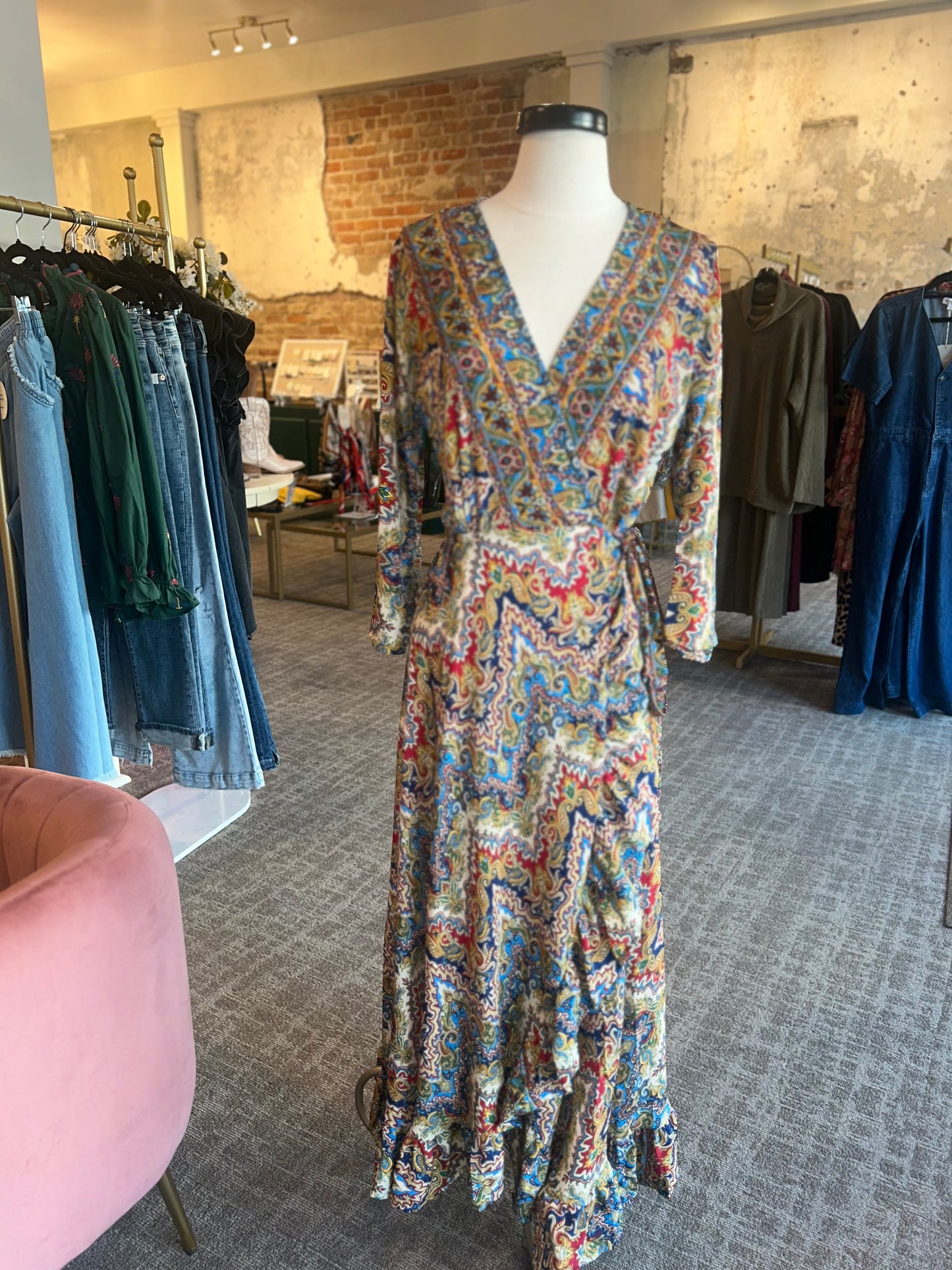 Colorful patterned dress on a mannequin in a clothing store.