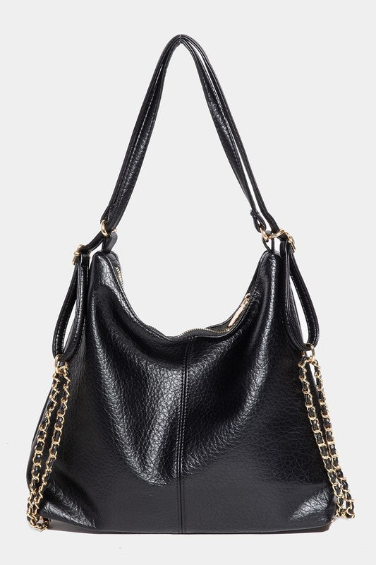 Black faux leather tote bag with gold chain straps, featuring a textured finish and spacious design, perfect for everyday use or as a stylish accessory for women.