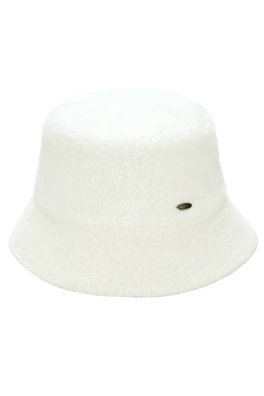 Ivory fuzzy bucket hat with a soft texture and a small metallic logo embellishment on the side.