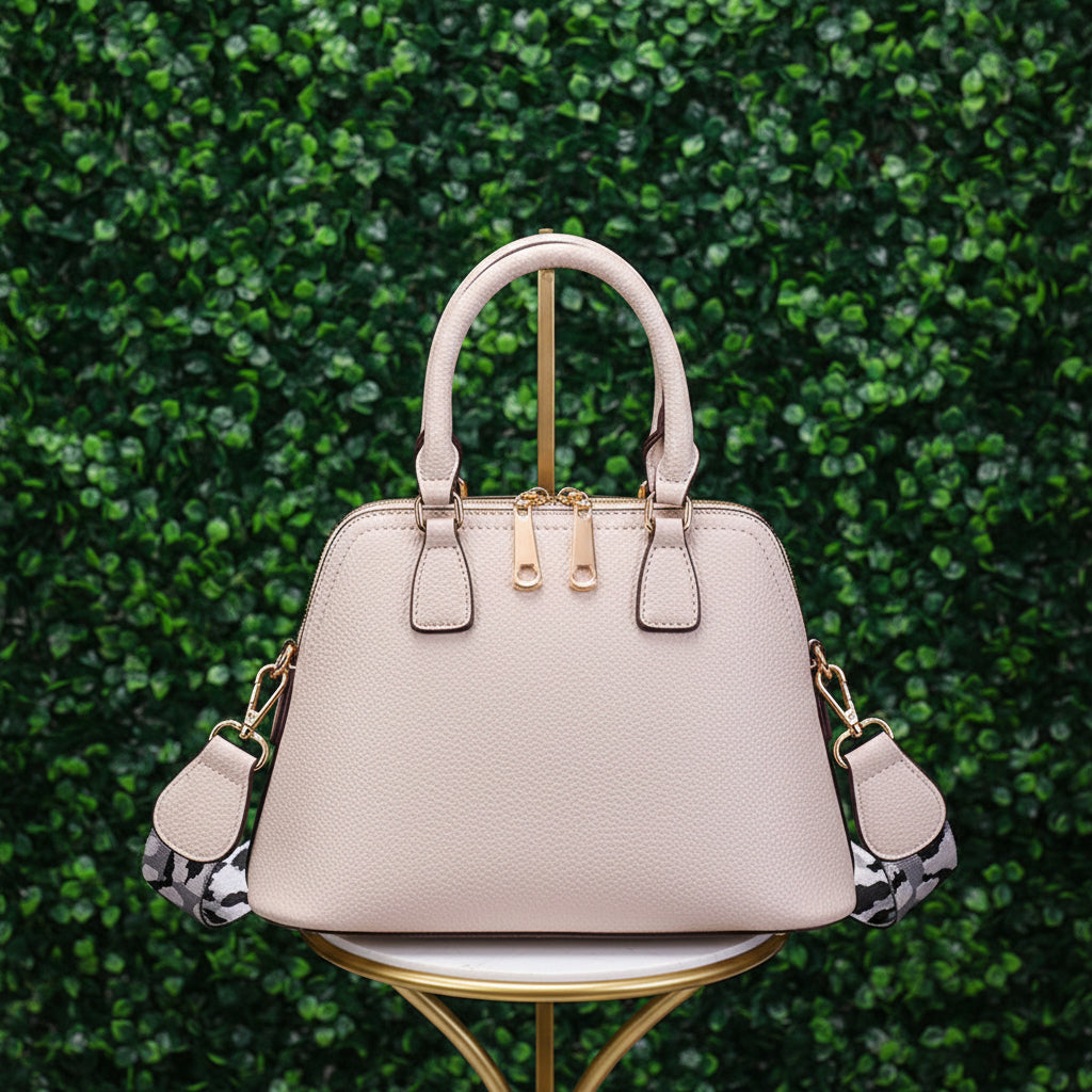 Beige handbag with gold accents on a white background