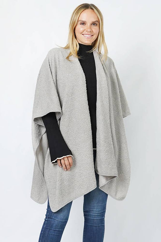  A cozy light gray open-front poncho with a textured, soft fabric. 