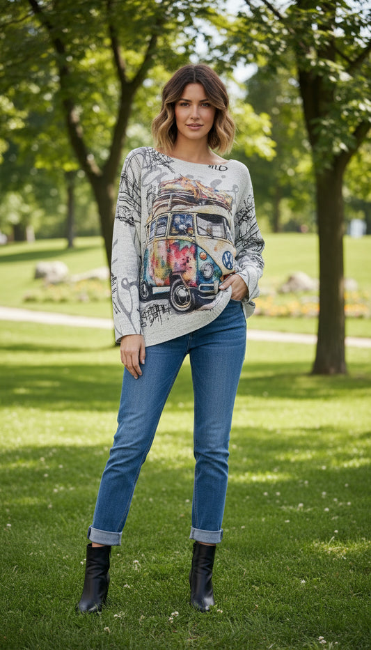 Sweater with a colorful Volkswagen bus design on a hanger against a white background